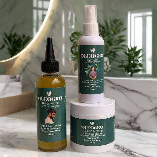 OLEOGRO hair care products on a marble surface with a mirror and plants in the background