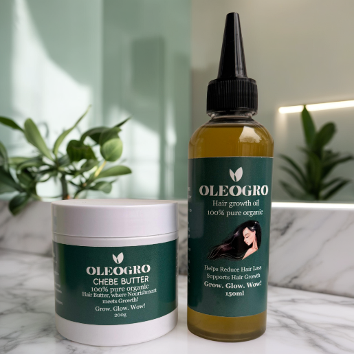 OLEOGRO chebe butter and hair growth oil on a marble surface with plants in the background