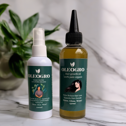 Two bottles of Oleogro hair care products on a marble surface with a plant in the background.